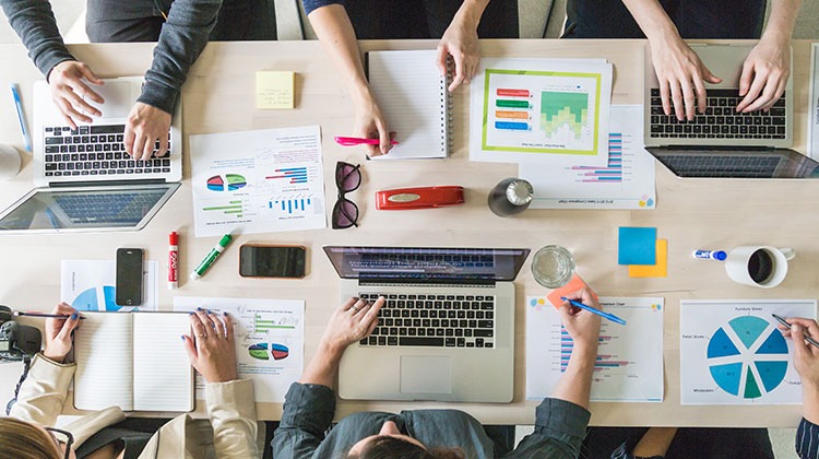 Business meeting with laptops and charts