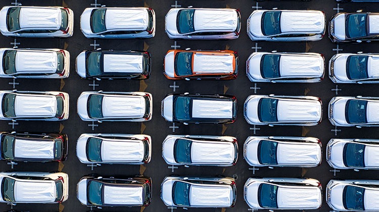 Aerial view of cars in parking lot showing scale